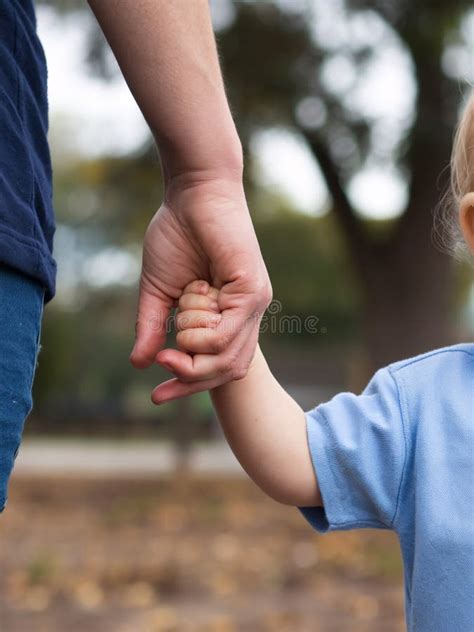 Thematic image: A parent holding a child's hand, symbolizing connection and loss.