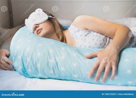 Pregnant woman wearing a comfortable nightgown in bed