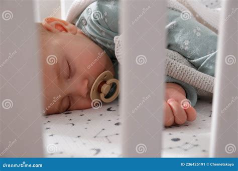 Baby sleeping peacefully with a pacifier