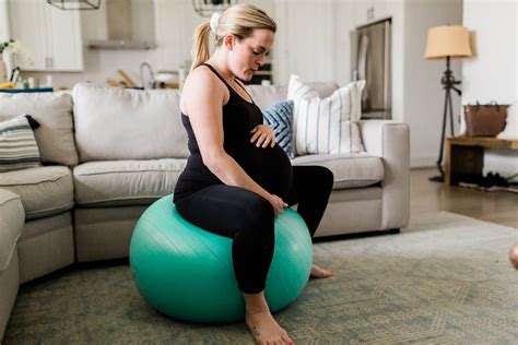 Pregnant woman exercising with a birthing ball
