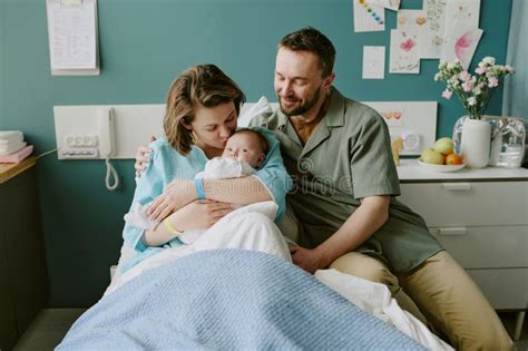 Parents holding their premature baby in a hospital