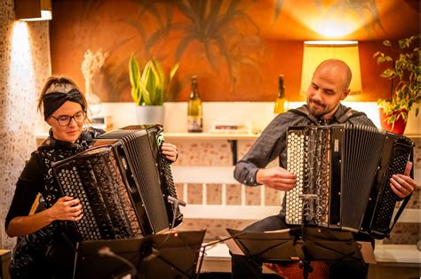 Michal Kriho playing harmonika with folklorists