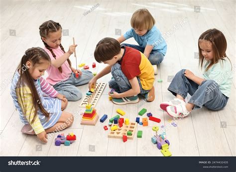 Small group of toddlers playing with an adult