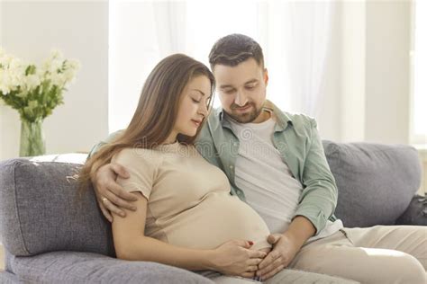 Parents touching pregnant belly