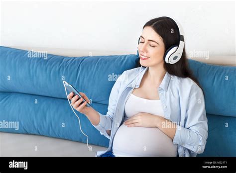 pregnant woman listening to music on headphones