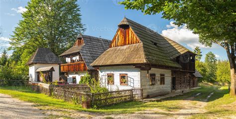 Slovak family by a traditional wooden house