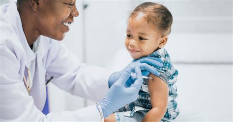 Thematic image: A child being vaccinated by a healthcare professional in a friendly environment.