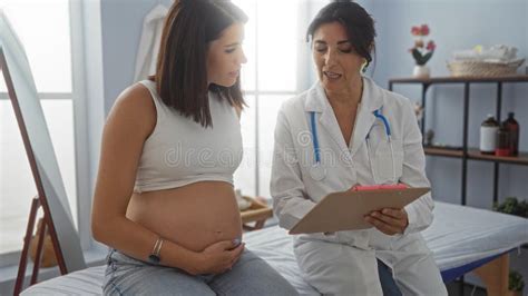 Pregnant woman consulting doctor