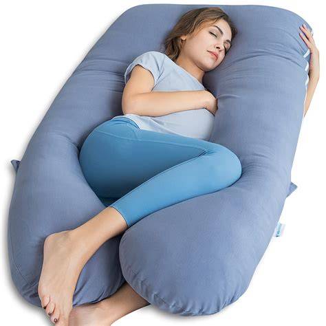 Pregnant woman sleeping with a pregnancy pillow