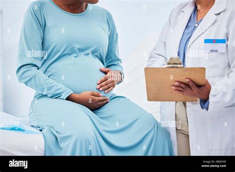 Woman consulting doctor about pregnancy test results