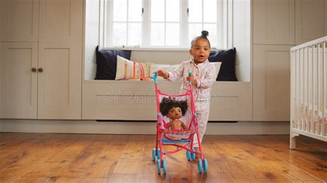 Child playing with a doll stroller