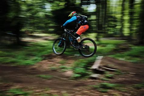 Dospelý človek jazdiaci na bicykli v prírode, usmieva sa
