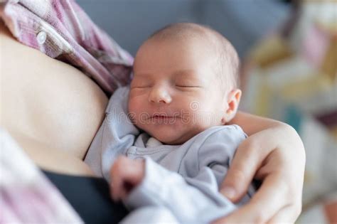 Mother breastfeeding baby peacefully