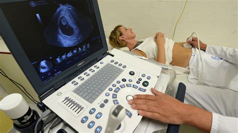 Pôrodníčka vysvetľujúca epidurálnu anestéziu tehotnej žene