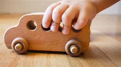 Child playing with wooden toys