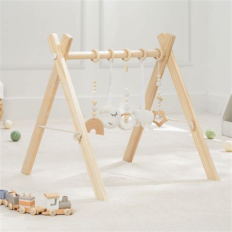 Child reaching for wooden playgym toys