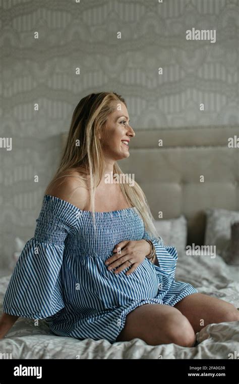 Pregnant woman feeling baby move in her belly