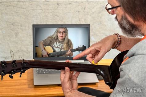 Guitar teacher giving online lesson to a child