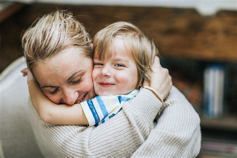 Child being hugged by parent