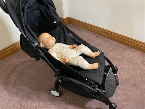 Child sleeping comfortably in a reclined stroller