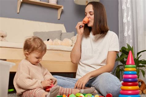 happy mother and toddler daughter playing together at home